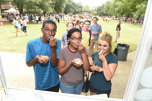 Three first-year students eating ice cream on Residential Quad